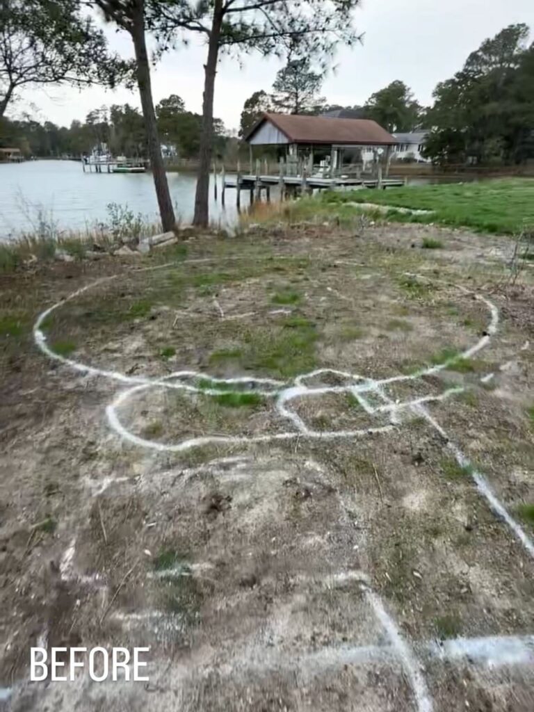 Before: waterfront lawn marked with a spray-painted patio layout in Poquoson, VA
