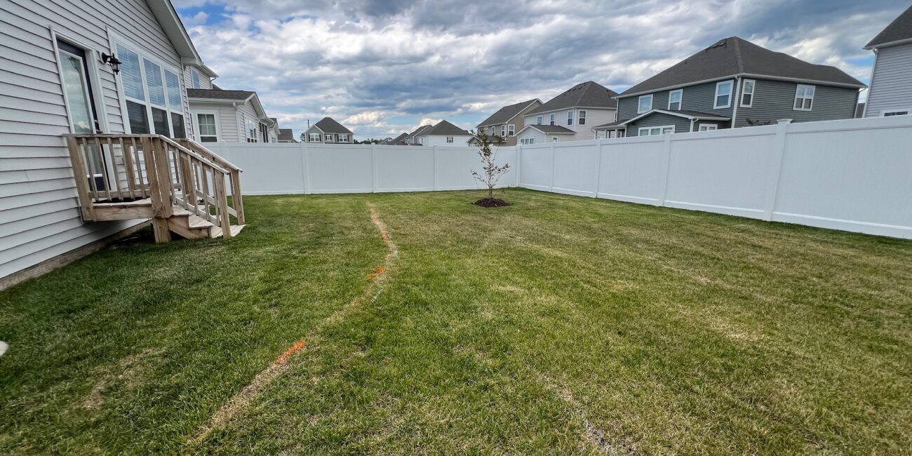 Before: open backyard lawn marked with spray-painted patio layout lines in Glen Allen, VA