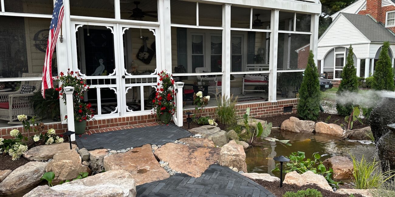 Front porch with pond, boulders and herringbone paver walkway in Poquoson, VA